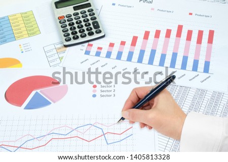 Financial Charts, graphs, coins, calculator on isolated white background. Top view with copy space.