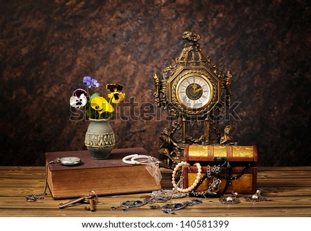 Jewellery, clocks and flowers on the table