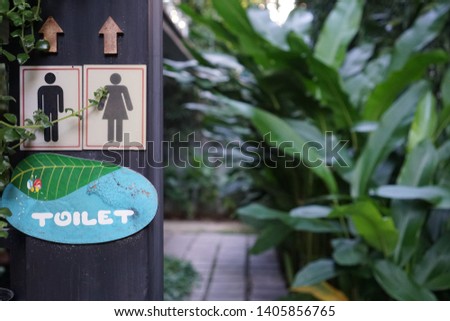 Public toilet sign in the garden