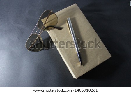 Book with Brown Cover (pen and glasses)