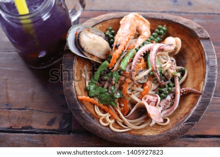 The Spaghetti basil fried seafood on a bowl of coconut water served with pea lemon. Add flavor to food