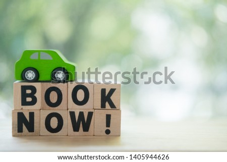 Miniatures car and words with book now. Concept of online car booking. Book taxi cab online internet booking