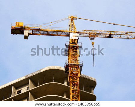 Building under construction. Construction site. Crane near building.