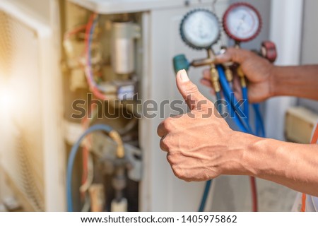 Close up of Air Conditioning Repair, repairman on the floor fixing air conditioning system Royalty-Free Stock Photo #1405975862