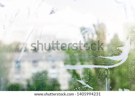 glass with foam background. abstraction. detergent on the window. - Image