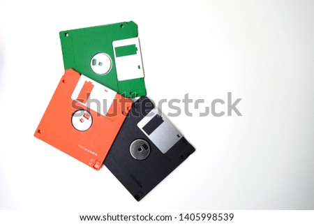 Floppy disk on white background.Floppy disk, green, orange, black