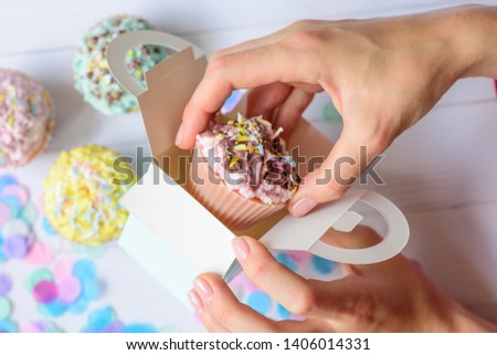 hands carefully pack goods cake