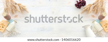 top view photo of dairy products over white wooden background. Symbols of jewish holiday - Shavuot Royalty-Free Stock Photo #1406016620