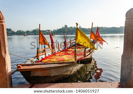 empty colorful wooden boat on the bank of river 