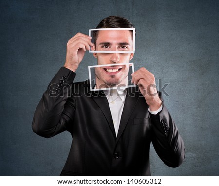 Businessman holding a smile over his face