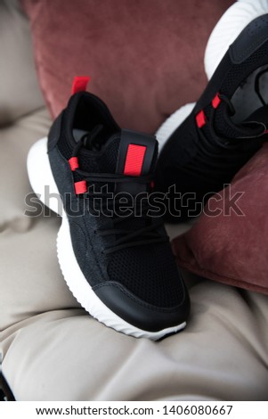 pair of black sneakers on different backgrounds.close picture