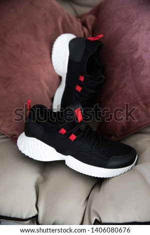 pair of black sneakers on different backgrounds.close picture