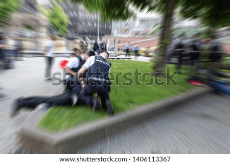 Police Officer in Action Put under Arrest a Criminal on Public Blurred Zoom Effect
