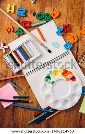 Notebook paper with office tools on wood table background
