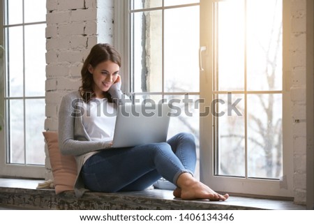 Beautiful young woman with laptop resting at home