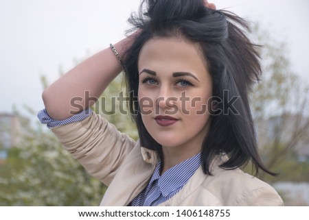 Magnificent passionate young brunette woman with perfect skin. Presenting your product. Expressive facial expressions. Copy space.
Her hands near her face. 
