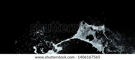 milk or white liquid splash isolated on black background