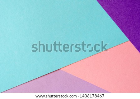 Multicolored paper background in soft blue, violet, lilac and coral colors.