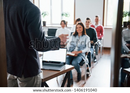 Cheerful mood. Group of people at business conference in modern classroom at daytime.