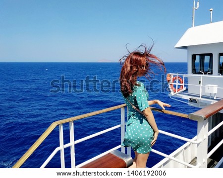 Beautiful young woman on a sailing ship in the Mediterranean Sea