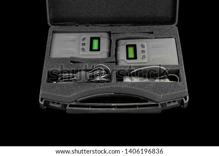 Wireless microphone transmitter for digital camera on black background.