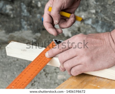 Hobby, carpenter measures the board with the meter tape