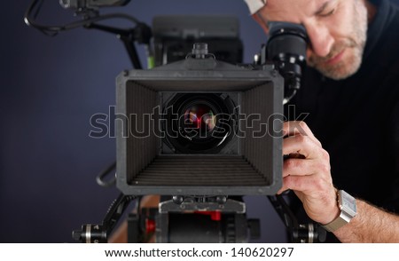 close-up of camera operator working with a cinema camera