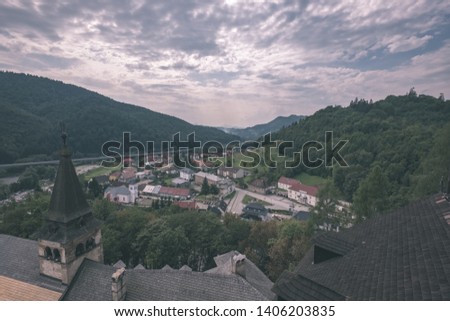 country village rooftops in Slovakia with mountains in background - vintage retro look