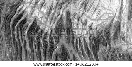 the son of the volcano, allegory, abstract naturalism, Black and white photo, abstract photography of landscapes of the deserts of Africa from the air, aerial view, contemporary photographic art, 