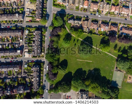Aerial photo of the British town known as Crossgates in Leeds West Yorkshire, the photo shows rows of houses, traffic on the roads and playing fields, taken with a drone on a beautiful sunny day
