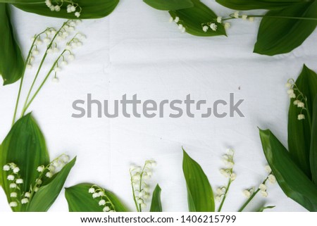 Ladnys on the table. Natural background Convallaria. Lily of the valley and inflorescences on a white background. wreath of lily of the valley.
Lilium convallium