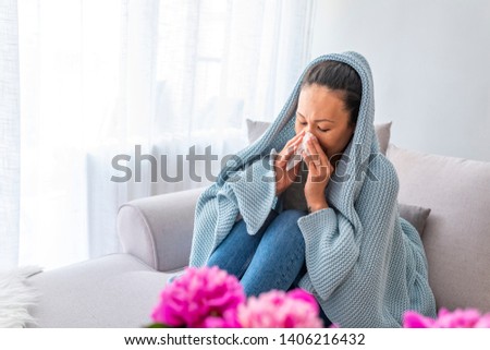 Woman sneeze on bed. Flu. Young woman got nose allergy, flu sneezing nose sitting at home. Asian woman suffering from flu with tissue
