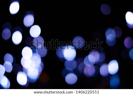 Out of Focus Abstract Lights / Bokeh, white, blue and purple with black dark background.