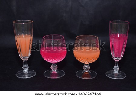 Mock up  design set of elegant and traditional drink ware / drinking glass for wine and juice, transparent and colorful  isolated on black background template for branding identity and company logo