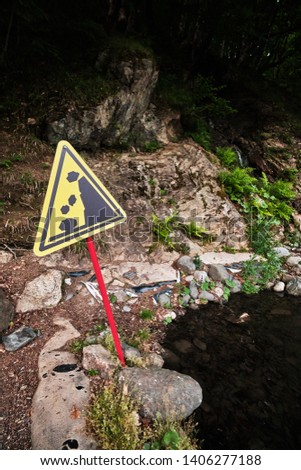 sign warning of danger. Rock slide area