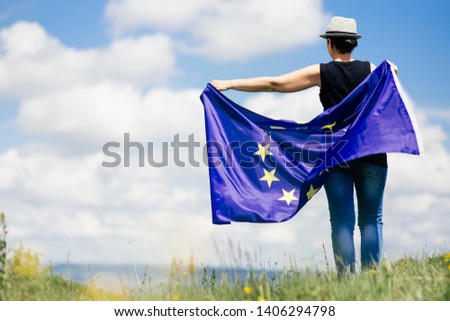 Young woman holding the European Union Flag. Voting concept.