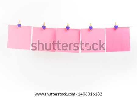 Pink stickers on clothesline with clothespins isolated on white background. Place for your text.
