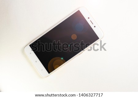 mobile phone with black screen , tinted on a light background, with highlights of light