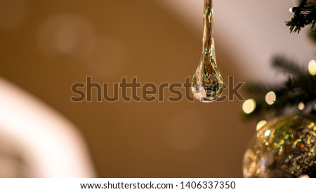 A beautiful water drop decoration on a branch for Christmas  Royalty-Free Stock Photo #1406337350