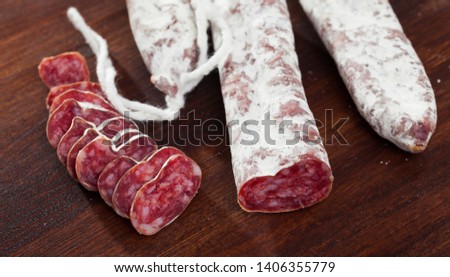 Sliced Catalan sausage Fuet on wooden background