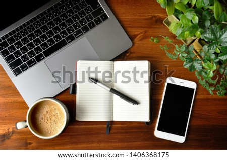 mobile phone and notebook on a table
