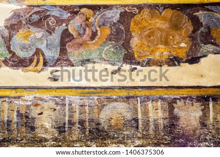 A fade image of an ancient mural art on the wall.