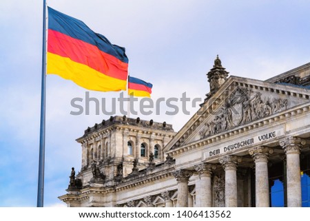 Reichstag building architecture and German Flags at Berlin, capital of Germany in winter in the street. German Bundestag parliament house. Royalty-Free Stock Photo #1406413562