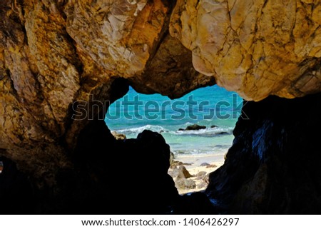Naturally created beautiful heart-shape cave with beautiful sea as background.