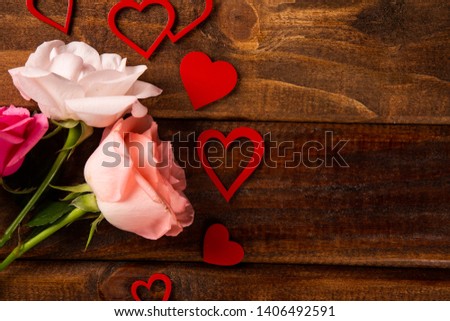 Valentine background with flowers and handmade hearts on rustic wood, copy space. Valentine's Day, love, romantic concept. Horizontal orientation