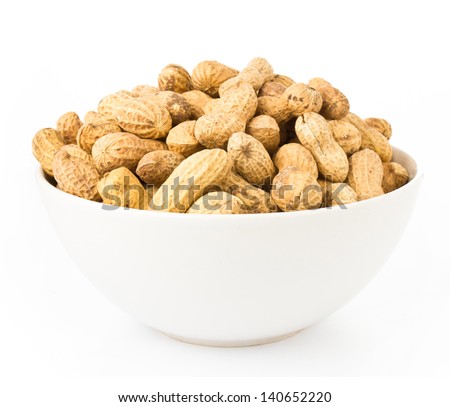 Raw shelled great peanuts in a bowl on white background, Royalty-Free Stock Photo #140652220