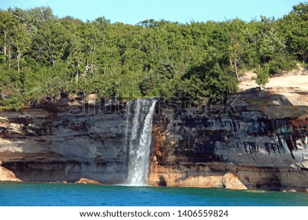 Pictured Rocks with a waterfall, photographed from Lake Superior, Michigan, USA
