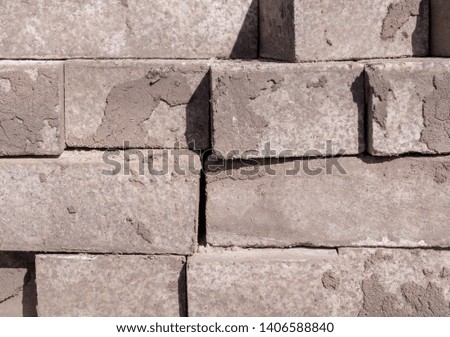stack of gray pavement cobblestones, bricks. texture, construction.