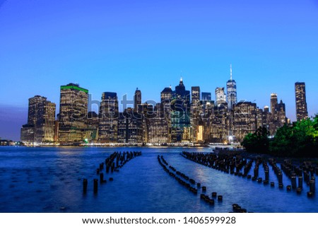 Manhattan at dusk viewed from the Brooklyn Bridge Park in New York City