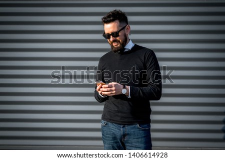 Stylish succsesful man with a beard on the street